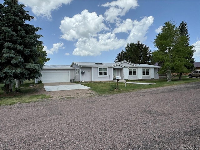 ranch-style house featuring a garage and solar panels