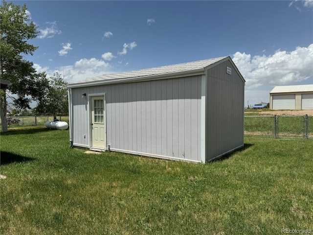 view of outbuilding with a lawn