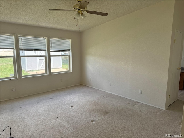 unfurnished room featuring light carpet, ceiling fan, and a wealth of natural light