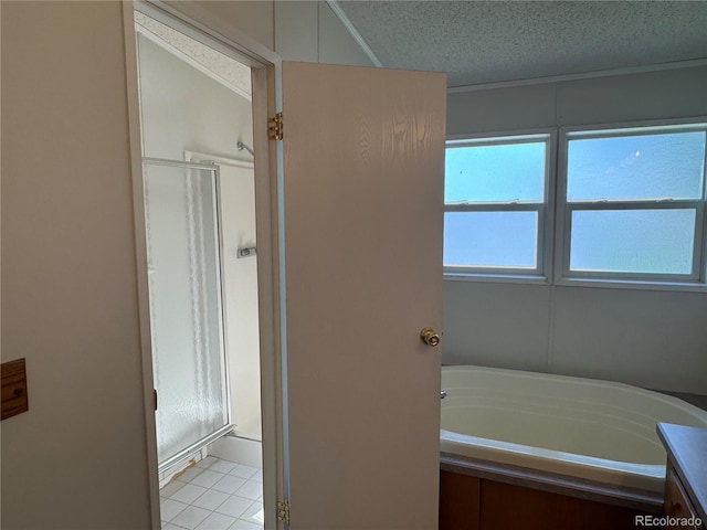 bathroom featuring a textured ceiling, shower with separate bathtub, tile patterned floors, and vanity