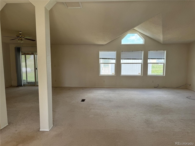 carpeted empty room with ceiling fan, a textured ceiling, and vaulted ceiling