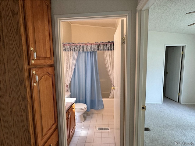 full bathroom with a textured ceiling, tile patterned floors, vanity, toilet, and shower / bath combo with shower curtain