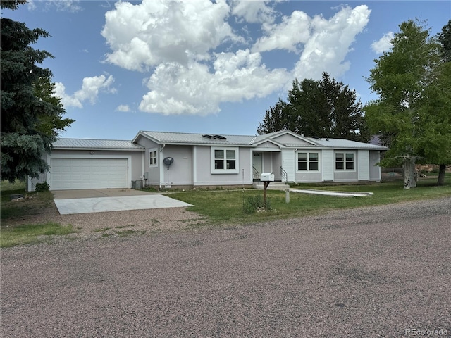 single story home with a garage, a front lawn, and solar panels