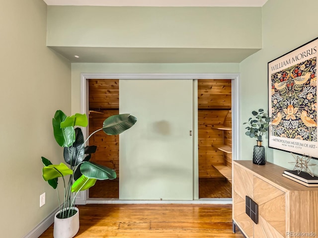 interior space with baseboards and wood finished floors