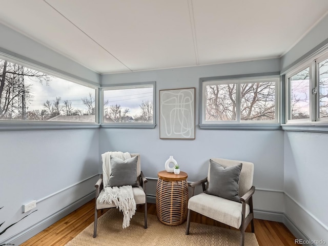 sitting room with wood finished floors and baseboards