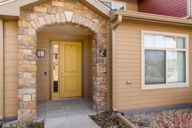 view of exterior entry featuring stone siding