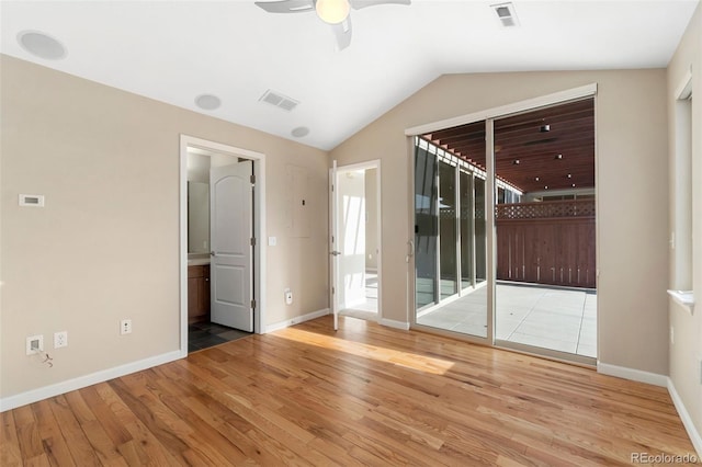 empty room featuring ceiling fan, lofted ceiling, and light wood-type flooring