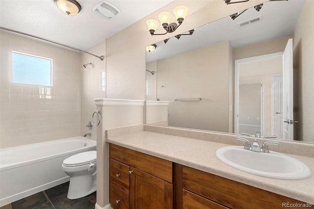 full bathroom featuring tiled shower / bath combo, vanity, and toilet