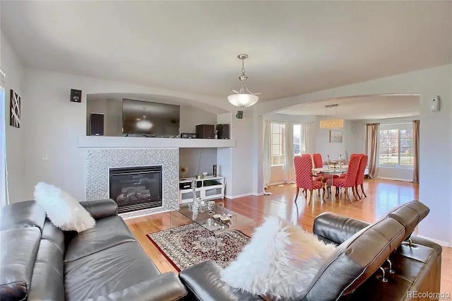16893 Trail View Cir, Parker, CO 80134 - living room with wood finished floors, a tiled fireplace, and baseboards