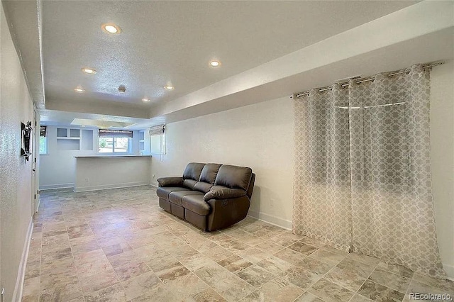 16893 Trail View Cir, Parker, CO 80134 - living area with recessed lighting, baseboards, a raised ceiling, and light stone finish floors