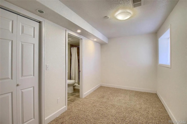 16893 Trail View Cir, Parker, CO 80134 - basement with light colored carpet, a textured ceiling, and baseboards