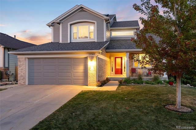 view of front of house featuring a yard and a garage