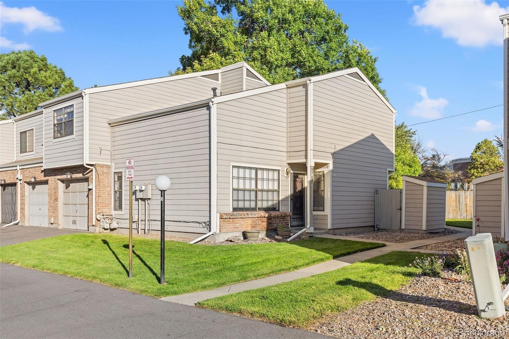 view of front of house with a garage and a front lawn