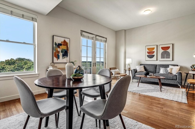 dining room with baseboards and light wood-style floors