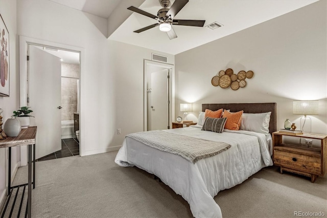 carpeted bedroom featuring visible vents, baseboards, connected bathroom, and a ceiling fan