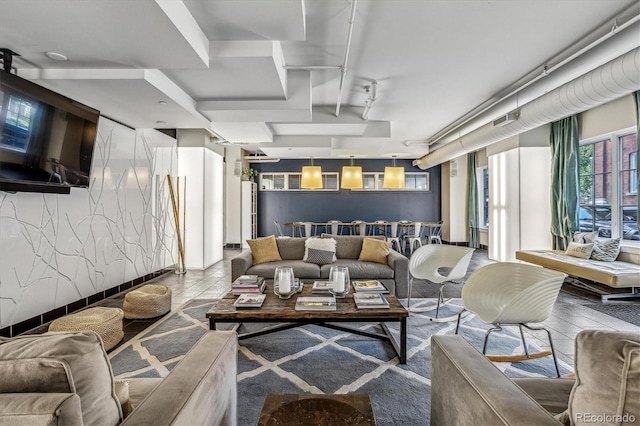 living area featuring tile patterned floors and track lighting