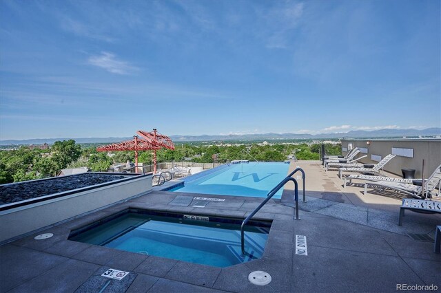 410 Acoma St Unit 518, Denver, CO 80204 - community pool with a hot tub, a mountain view, and a patio