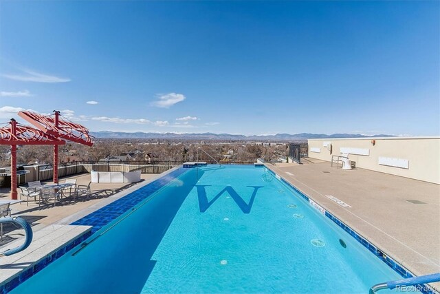 410 Acoma St Unit 518, Denver, CO 80204 - community pool featuring a mountain view, a patio area, and fence