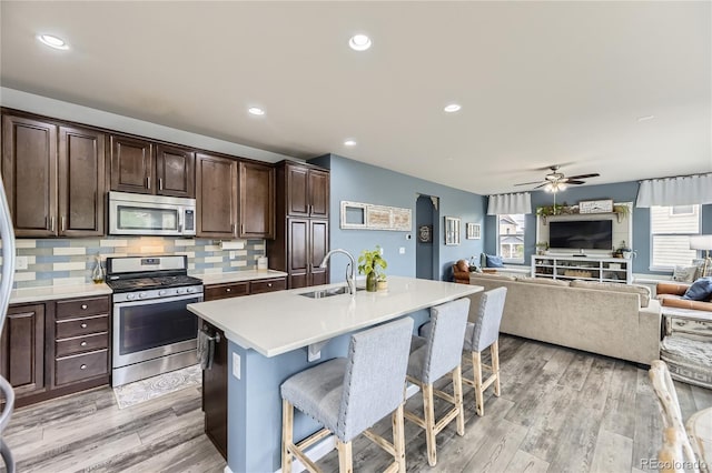 3944 Trail Stone Cir, Castle Rock, CO 80108 - kitchen featuring stainless steel appliances, a kitchen breakfast bar, plenty of natural light, light countertops, and recessed lighting