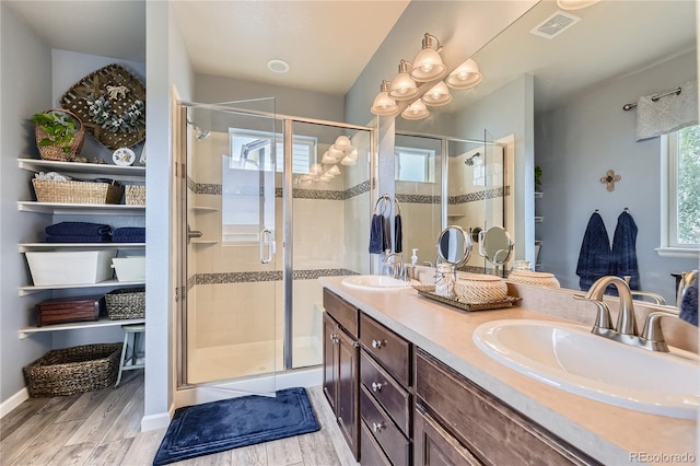3944 Trail Stone Cir, Castle Rock, CO 80108 - bathroom with wood finished floors, double vanity, and a shower stall
