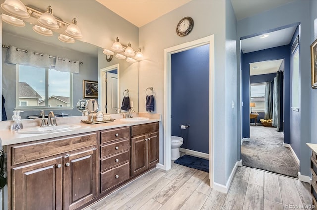 3944 Trail Stone Cir, Castle Rock, CO 80108 - full bathroom featuring wood finished floors, double vanity, and healthy amount of natural light