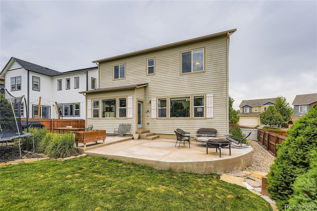 3944 Trail Stone Cir, Castle Rock, CO 80108 - back of house with a trampoline, a patio, an outdoor fire pit, and entry steps