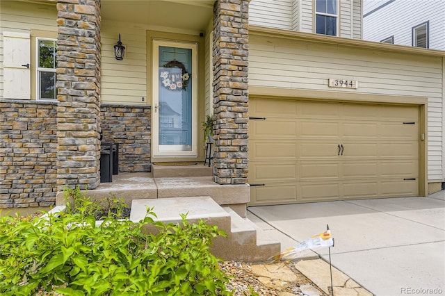 3944 Trail Stone Cir, Castle Rock, CO 80108 - property entrance with a garage, stone siding, and driveway