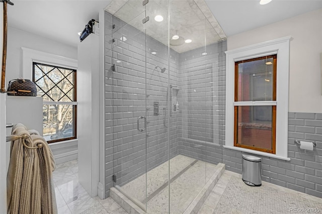 1351 N Franklin St, Denver, CO 80218 - bathroom featuring a stall shower, marble finish flooring, recessed lighting, wainscoting, and tile walls
