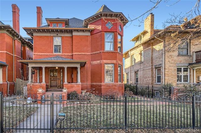 1351 N Franklin St, Denver, CO 80218 - view of front facade with brick siding, a fenced front yard, a porch, and a shingled roof