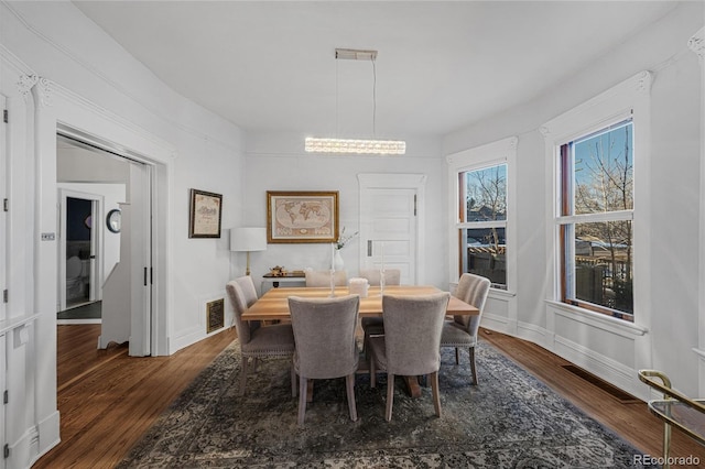 1351 N Franklin St, Denver, CO 80218 - dining area featuring dark wood-type flooring and a chandelier