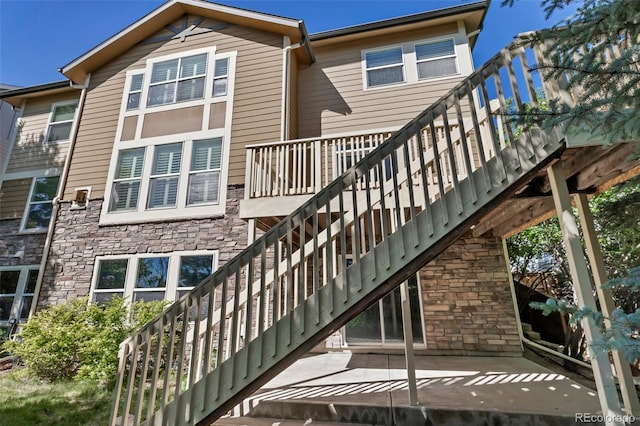 10646 Amesbury Way, Highlands Ranch, CO 80126 - back of house with stairs and stone siding