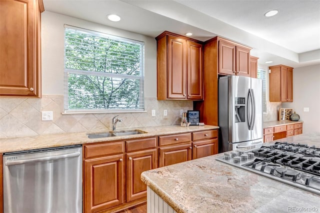 10646 Amesbury Way, Highlands Ranch, CO 80126 - kitchen featuring stainless steel appliances, recessed lighting, brown cabinets, and light stone countertops