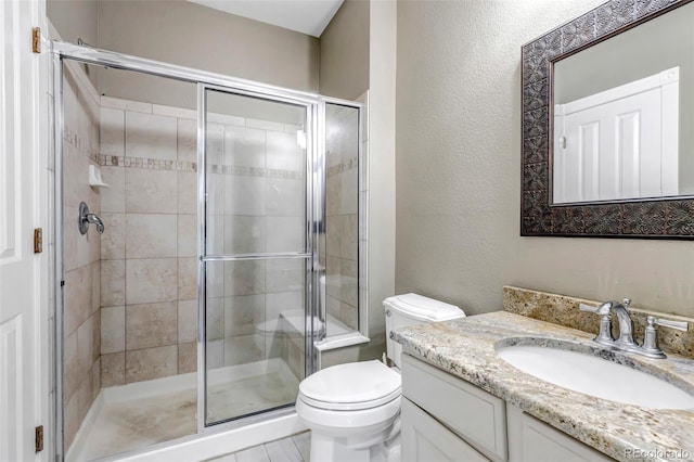10646 Amesbury Way, Highlands Ranch, CO 80126 - bathroom with vanity, a stall shower, and a textured wall