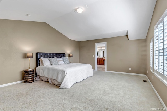 10646 Amesbury Way, Highlands Ranch, CO 80126 - bedroom featuring vaulted ceiling, light colored carpet, and connected bathroom