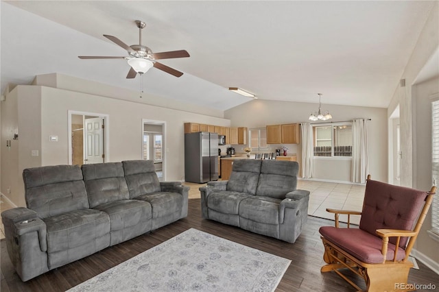 living room featuring ceiling fan with notable chandelier, lofted ceiling, and hardwood / wood-style floors