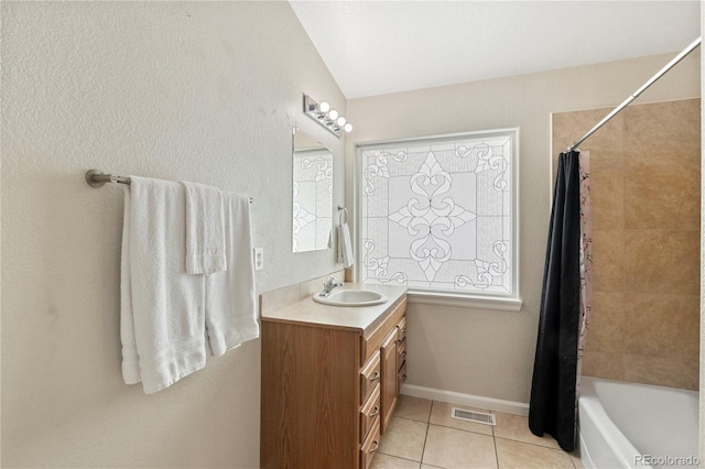 bathroom with tile patterned flooring, vanity, and shower / tub combo with curtain