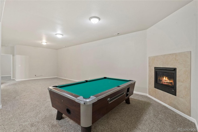 recreation room featuring a tiled fireplace, light colored carpet, and billiards