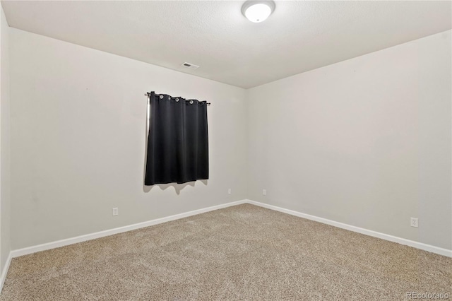 unfurnished room featuring carpet floors and a textured ceiling