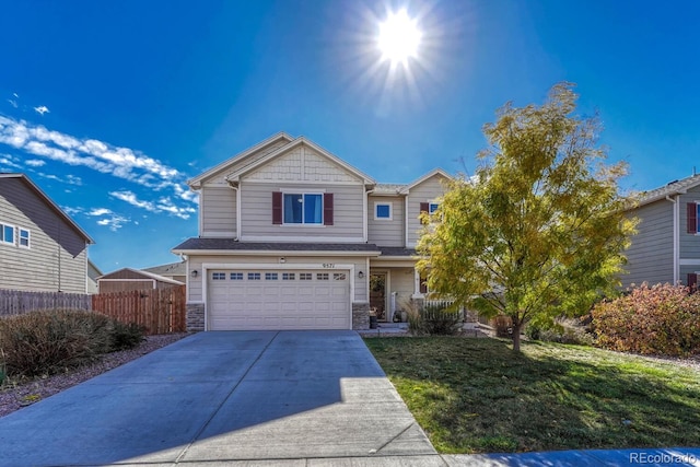 view of front of home with a front lawn and a garage