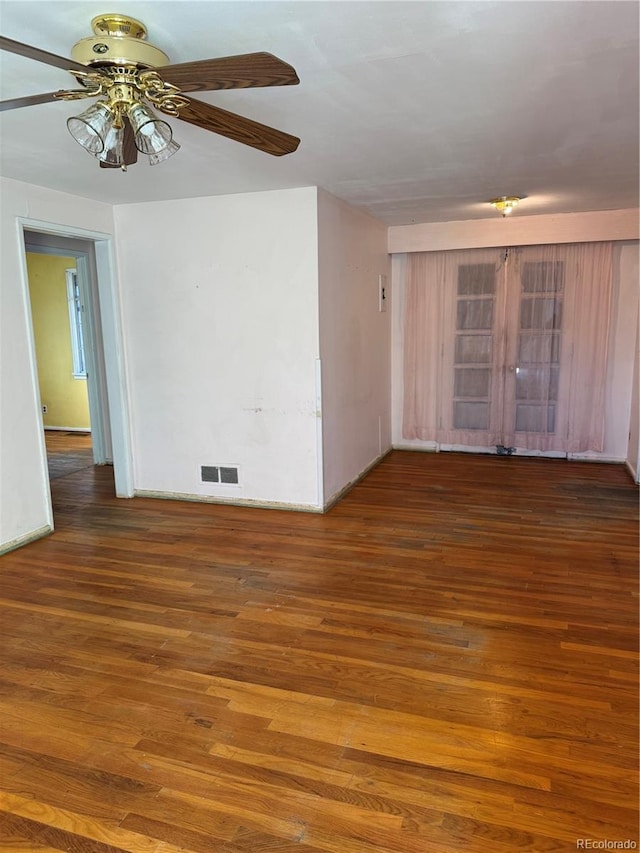 empty room featuring ceiling fan and dark hardwood / wood-style floors