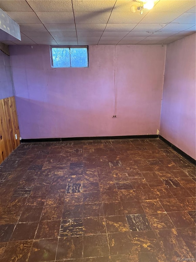 basement with a paneled ceiling