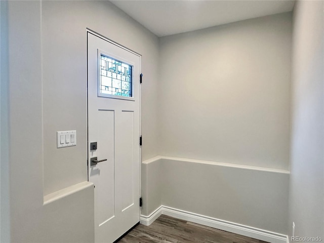 entryway featuring baseboards and dark wood-style flooring