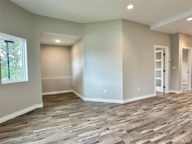 unfurnished room with recessed lighting, baseboards, and wood finished floors