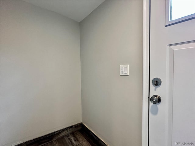 interior space featuring wood finished floors and baseboards