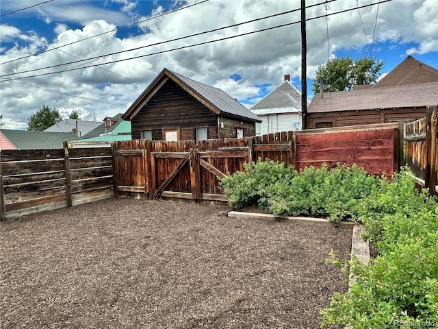 view of yard featuring a fenced backyard and a gate