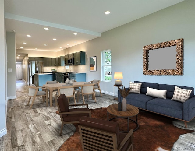 living area featuring recessed lighting, light wood-type flooring, and baseboards