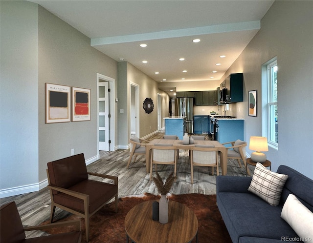 living area featuring recessed lighting, wood finished floors, and baseboards