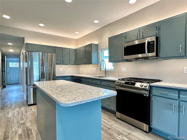 kitchen featuring light countertops, recessed lighting, light wood-style flooring, stainless steel appliances, and a sink