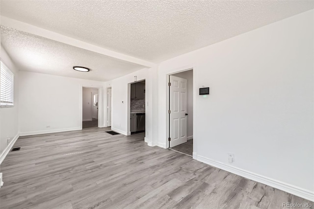 1537 Xenia St, Denver, CO 80220 - interior space featuring a textured ceiling, wood finished floors, and baseboards