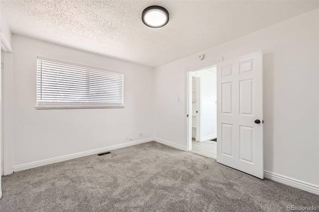 1537 Xenia St, Denver, CO 80220 - unfurnished bedroom with baseboards, carpet flooring, visible vents, and a textured ceiling